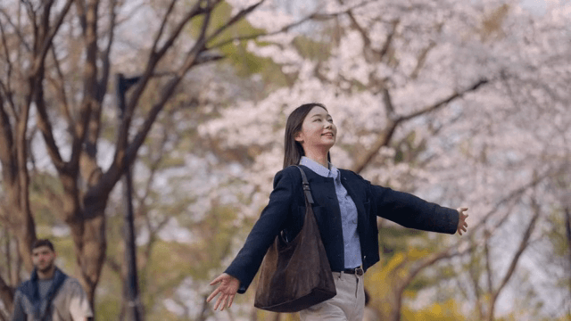 Woman enjoying cherry blossoms in spring