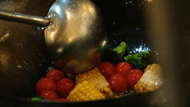 Vegetables stir-fried in hot wok