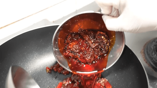 Chili peppers and mala sauce poured into pan