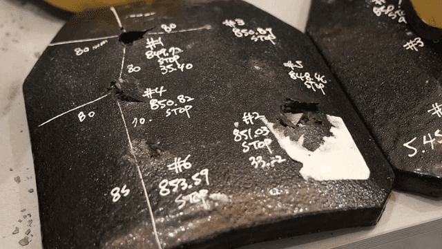 Tested metal plates with bullet impacts