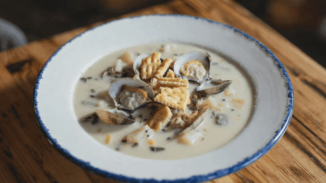 Creamy clam soup topped with crackers