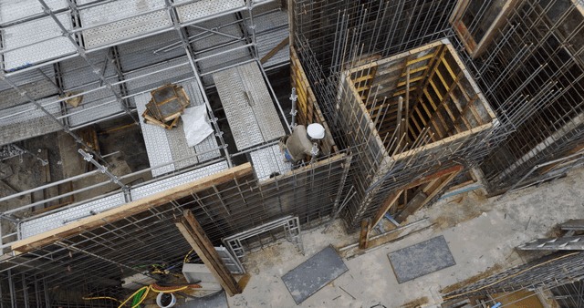 Construction site with scaffolding and worker