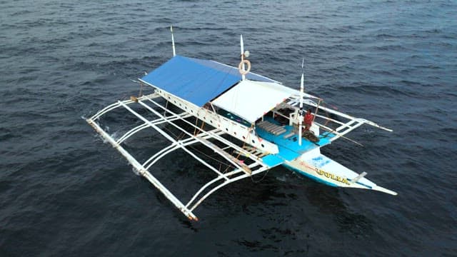 Bangka, a traditional Filipino boat floating on the peaceful and vast sea