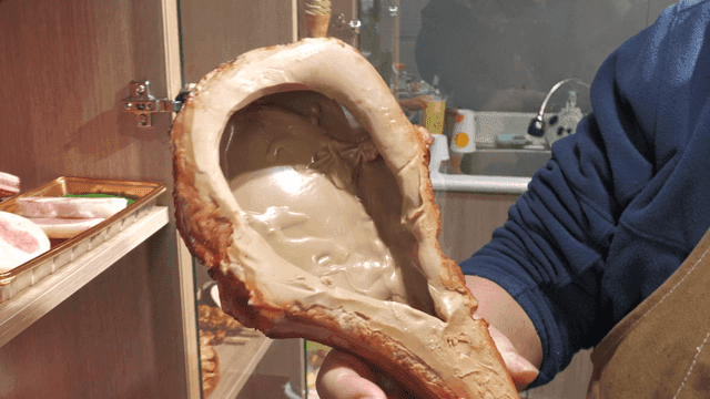 Person holding large grilled steak food model