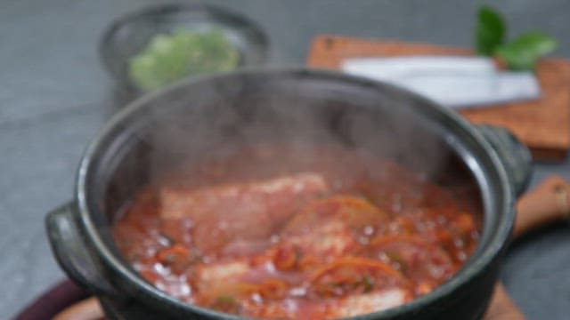 Braised hairtail with radish and spicy seasoning boiling in a pot