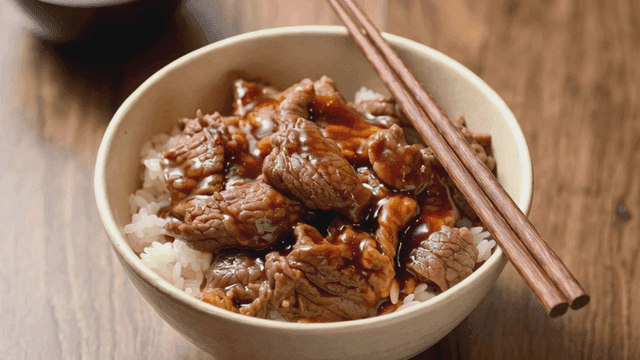 Beef Gyudon rice bowl topped with sauce