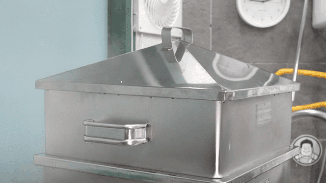 Metal steamers stacked in a kitchen