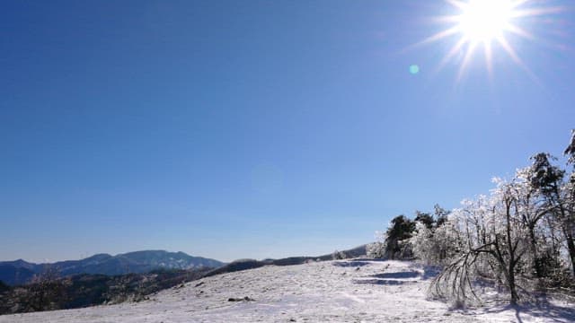 Snowy Mountain Landscape under Bright Sun