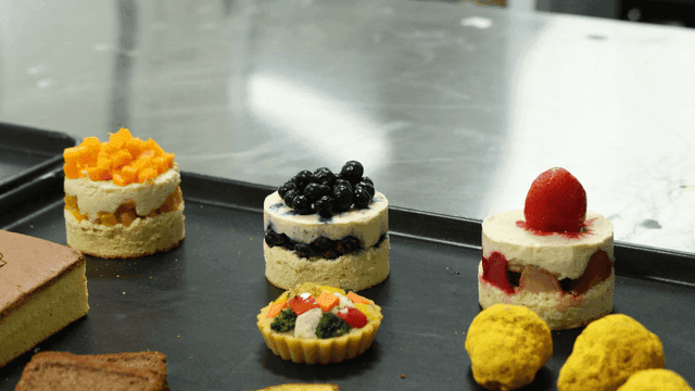 Assorted desserts on a tray in a kitchen