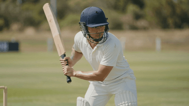 Cricket player preparing to hit on field