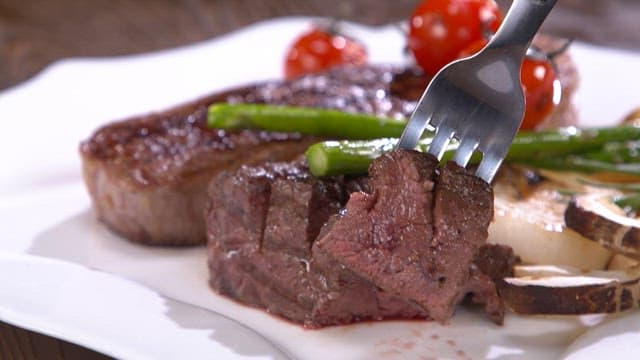 Juicy beef steak with asparagus and tomatoes