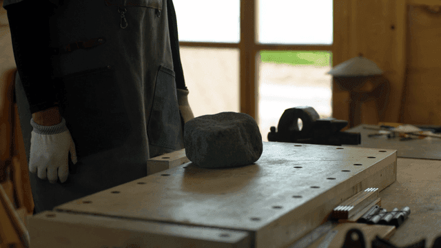 Person working with a stone in a workshop