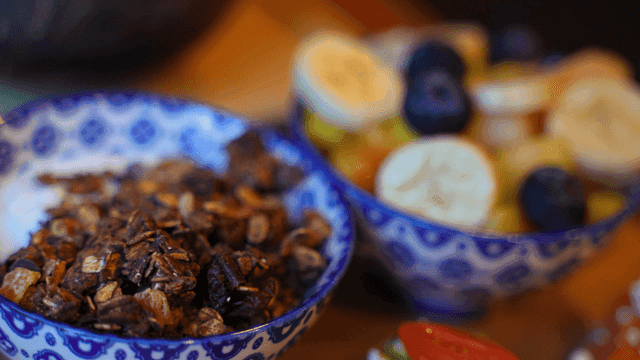 Colorful fruit and granola in bowls