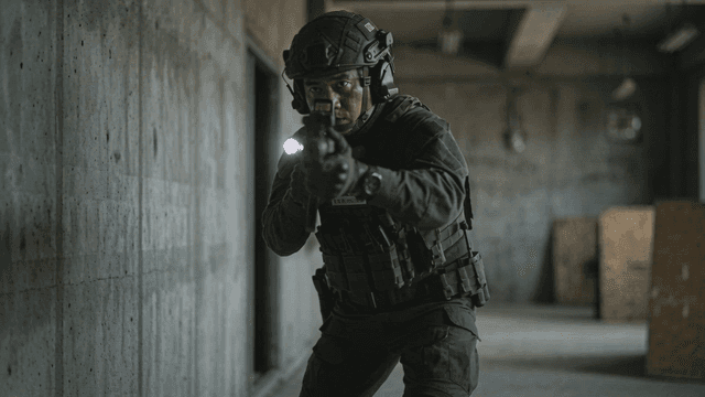 Soldiers moving cautiously on battlefield