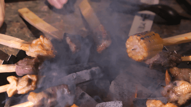 Grilling over charcoal brazier skewers