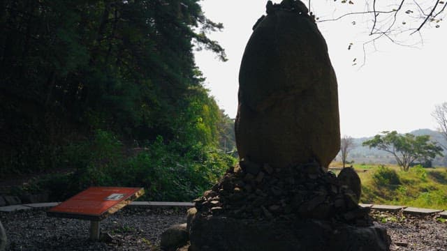 Rock tower surrounded by trees and greenery