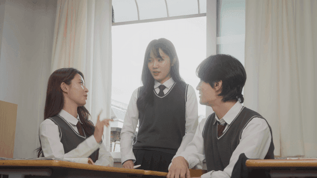 Students talking together in a bright classroom