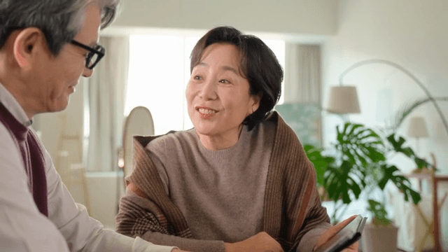 Elderly couple looking at a tablet together and talking