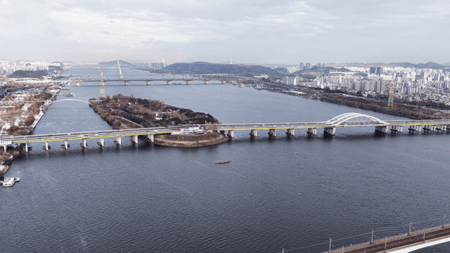 Aerial view of river with bridge and city in view