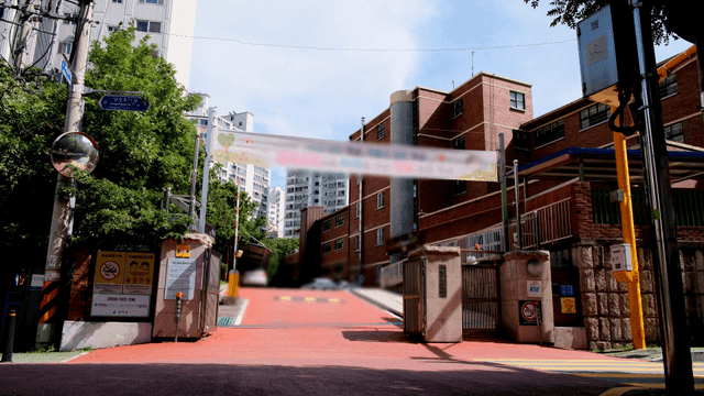 Entrance of a school with a red pathway