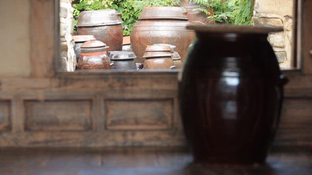 Traditional Korean jar on the floor of a quiet Hanok