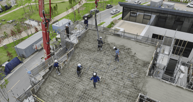 Construction workers pouring concrete