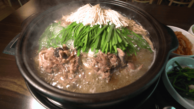 Hot duck soup with chives and mushrooms