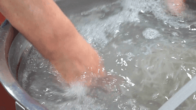 Chopsticks washing ice fish in basin of water