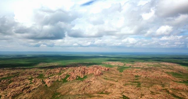 Vast rocky landscape under cloudy sky