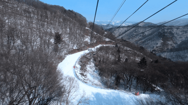 Snowy mountain landscape with cable cars