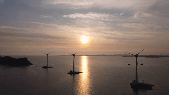 Wind turbines at sea during sunset