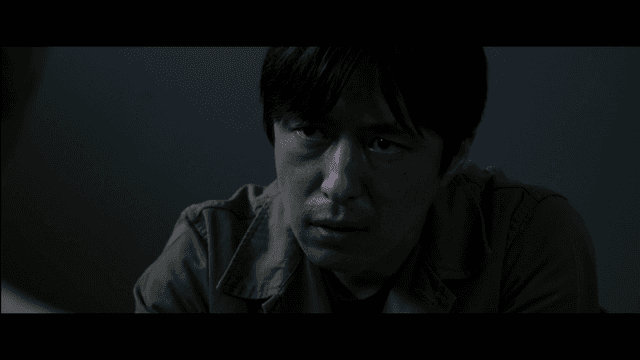 Man interrogating in dark room