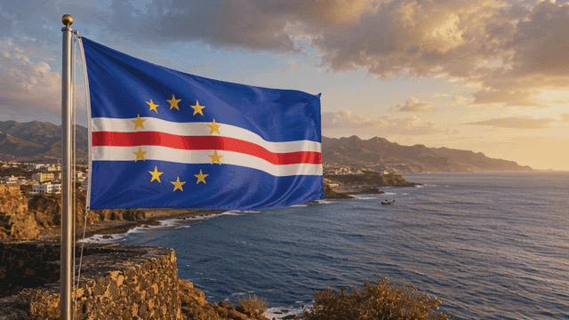Cape Verde flag fluttering by sea at sunset