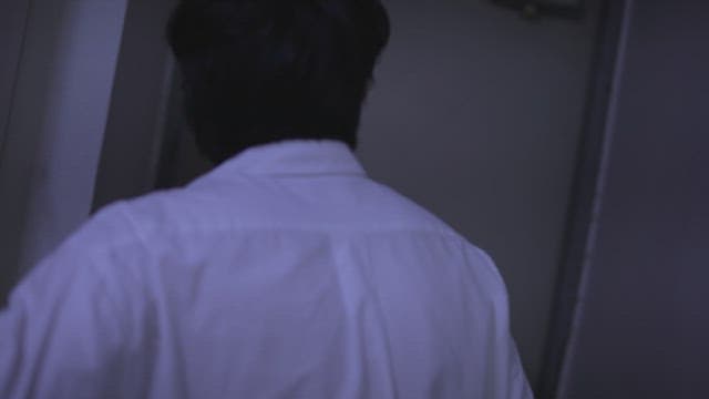 Man in a white shirt opens the front door and goes out into the hallway.