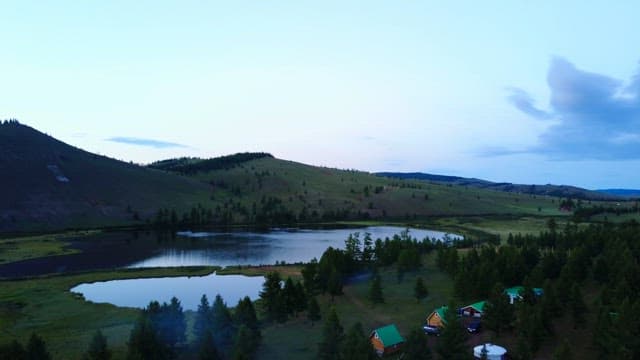 Serene lake surrounded by hills and trees