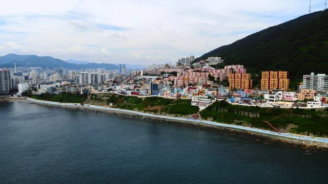 Colorful Coastal Cityscape with Mountains