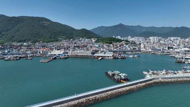 Coastal city with mountains in the background