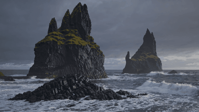 Waves crashing against rocky sea stacks