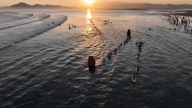 Paddleboarders at sunset on the ocean