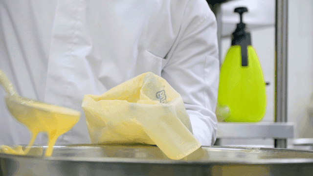 Chef preparing batter in a kitchen