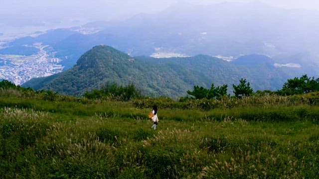 Woman Hiking on Mountain Trail Overlooking Valley