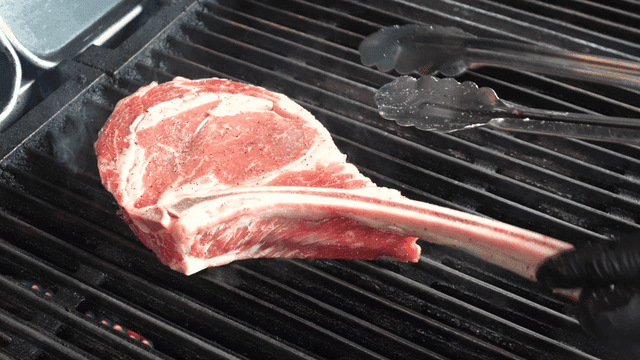 Tomahawk steak grilled on barbecue