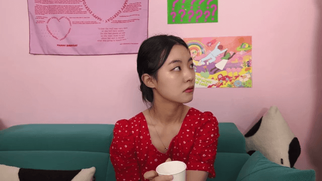 Woman in a red dress walking around the room