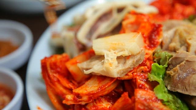 Eating boiled pork with kimchi