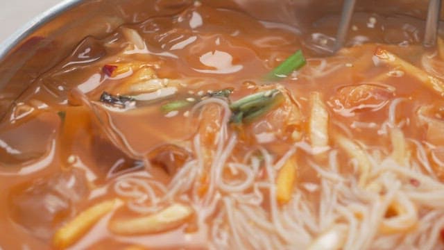 Chopstickful of noodles with sour cold raw fish soup