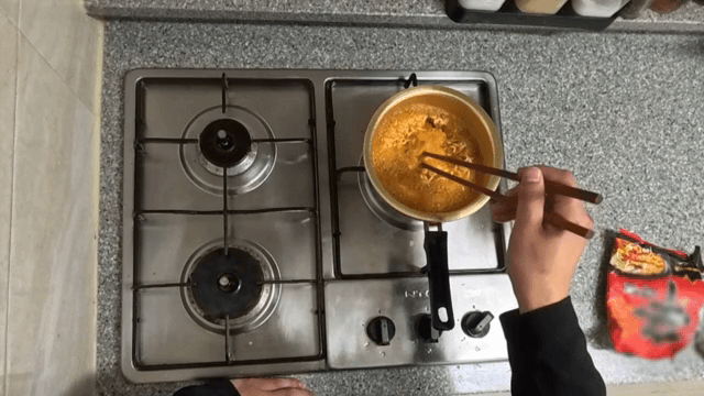 Cooking ramen in a pot on a stove