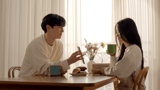 Couple taking photo of breakfast at dining table