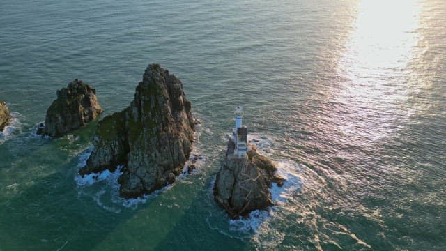 Lighthouse on a rocky island in the sea