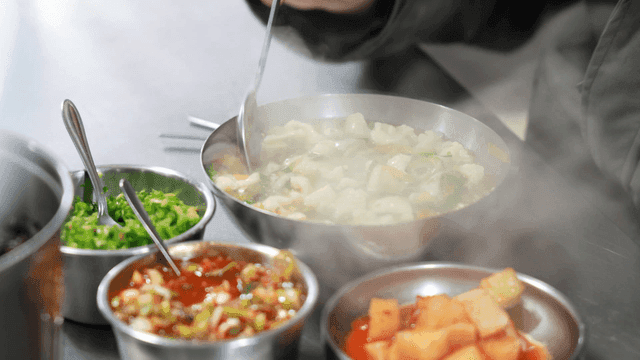 Steaming hot sujebi and side dishes