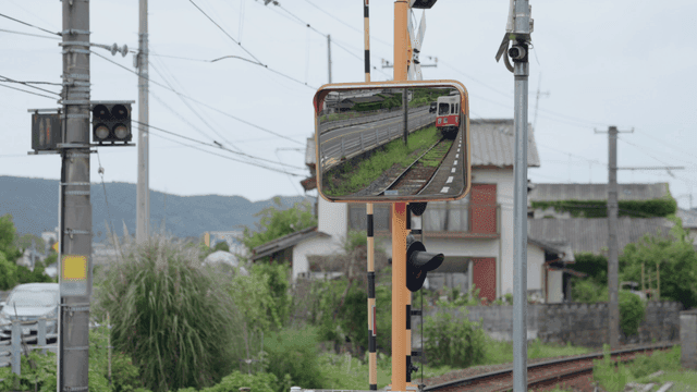 Train appearing in a roadside mirror